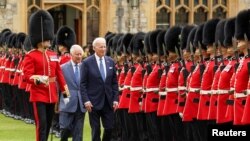 President Joe Biden participates in a ceremonial arrival and inspection of the honor guard with Britain's King Charles at Windsor Castle in Windsor, Britain, July 10, 2023.