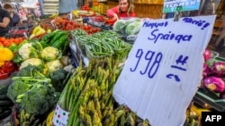 FILE - A cardboard displays the price of asparagus at the Bosnyak Market Hall in Budapest, Hungary, June 1, 2023. At 24.5 percent in April, inflation in Hungary was three times the EU average of 8.1 percent, with energy and food price inflation at 42 and 38 percent respectively.