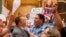 Pastor Michael Shover of Christ the Redeemer Church in Pella, left, argues with Ryan Maher, of Des Moines, as protestors clash in the Iowa State Capitol rotunda, July 11, 2023. (Zach Boyden-Holmes/The Des Moines Register via AP)