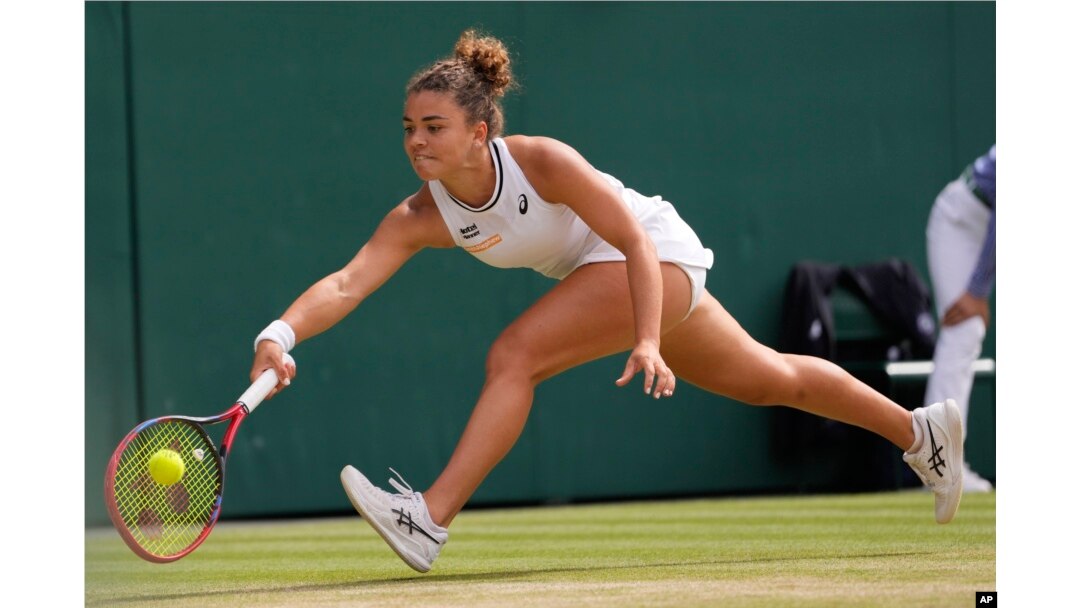 Jasmine Paolini of Italy plays a forehand return to Barbora Krejcikova of the Czech Republic during the women's singles final at the Wimbledon tennis championships in London, July 13, 2024.