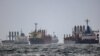 FILE - Vessels await inspection under the Black Sea Grain Initiative, brokered by the United Nations and Turkey, in the southern anchorage of the Bosphorus in Istanbul, Turkey, Dec. 11, 2022. 