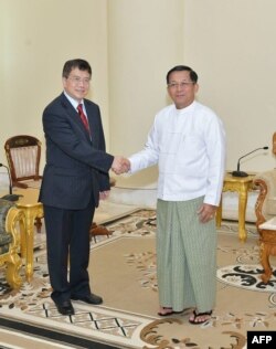 FILE - Myanmar junta chief Min Aung Hlaing, right, receives Chinese envoy Deng Xijun in Naypyidaw, Dec. 29, 2022.