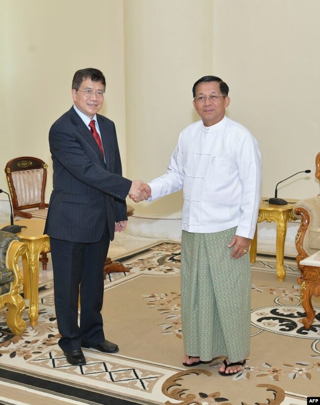 FILE - Myanmar junta chief Min Aung Hlaing, right, receives Chinese envoy Deng Xijun in Naypyidaw, Dec. 29, 2022.