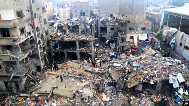 Palestinians search for survivors after an Israeli strike on a building in Jabaliya refugee camp, Gaza Strip, Nov. 14, 2023.