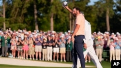 Scottie Scheffler celebrates his win at the Masters golf tournament at Augusta National Golf Club, in Augusta, Georgia, April 14, 2024. 