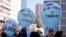 FILE - Students hold balloons that read in Spanish, "No to human trafficking," during a protest marking World Day Against Trafficking in Persons, in La Paz, Bolivia, July 29, 2022.