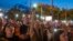 People use the lights on their mobile phones during a protest in Belgrade, Serbia, July 1, 2023.