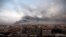 FILE - Smoke rises from town of Khan Younis after Israeli strikes on Sunday, December 10, 2023. 