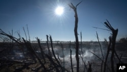 Smoke rises from the ruins of a farm after a recent Russian rocket attack in the village of Kiseliovka, which is close to Kherson, Ukraine, on Nov. 10, 2023.