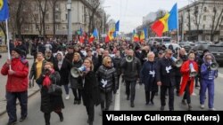 (FILE) People take part in an opposition rally to protest against the recent countrywide increase of power rates and prices in Chisinau, Moldova.