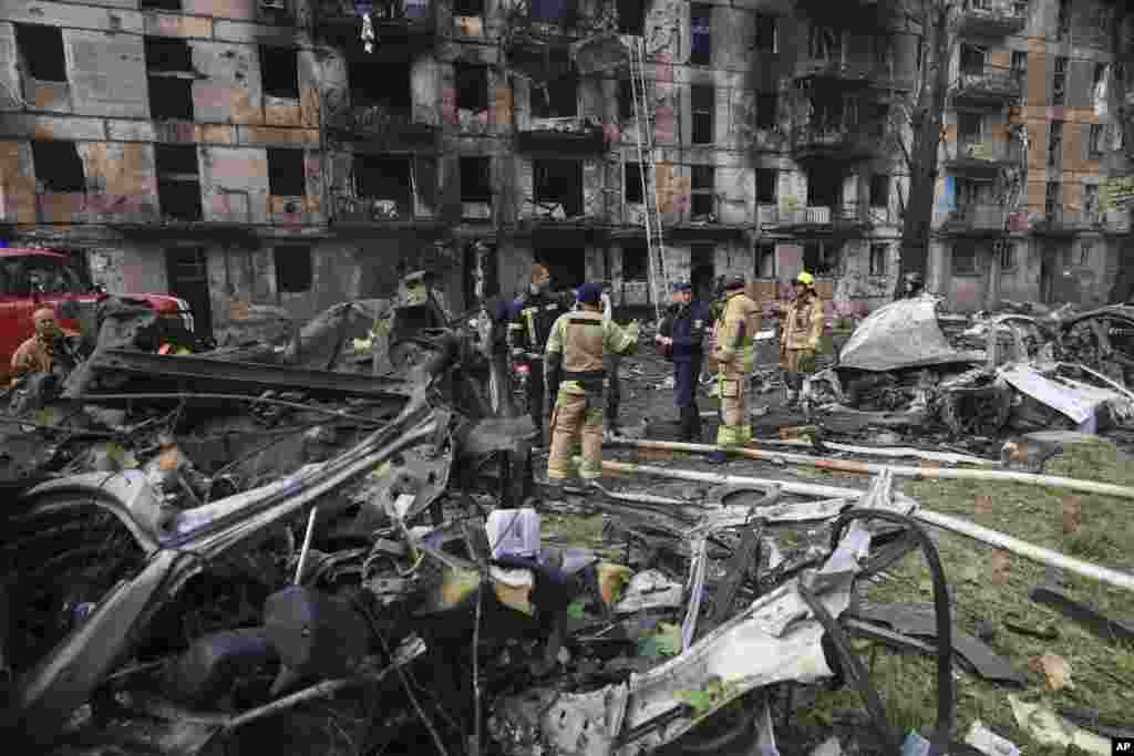 Emergency workers inspect a damaged apartment building hit by the latest rocket Russian attack in Kryvyi Rih, Ukraine.