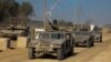 Konvoi kendaraan militer Israel bergerak di sepanjang jalan, di tengah invasi darat yang sedang berlangsung di Jalur Gaza terhadap kelompok Islam Palestina Hamas hari Rabu, 8 November 2023.