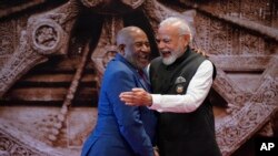 Indian Prime Minister Narendra Modi, right, shares a light moment with African Union Chairman and President of the Union of the Comoros Azali Assoumani upon his arrival for the G20 Summit in New Delhi, India, on Sept. 9, 2023.
