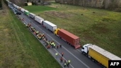 FILE - This aerial photo shows trucks standing near the Polish-Ukrainian border crossing of Dorohusk, Poland, Nov. 10, 2023.