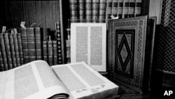 FILE - Two volumes of the over 500-year-old Gutenberg Bible are shown in New York in 1978. Johannes Gutenberg planned on printing 150 Bibles, but increasing demand motivated him to produce 30 extra copies, a total of 180. Around 48 complete 