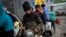 FILE - People wait in line for a free meal provided by the Casa Comunitaria del Fondo soup kitchen in Buenos Aires, Argentina, Nov. 1, 2023. An Argentine study says the country's poverty level reached a 20-year high in January. 