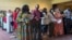 Dozens of people become U.S. citizens during a naturalization ceremony in St. Paul, Minnesota, June 21, 2023. The U.S. citizenship test is being updated and some immigrants and advocates worry the changes will hurt test-takers with lower levels of English proficiency.