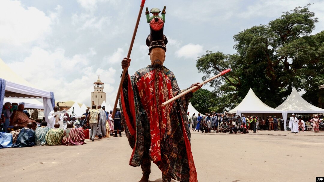A traditional masked dancer performs during the inauguration of the new Bamoun Kings Museum in Foumban, on April 13, 2024.