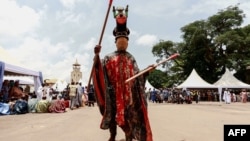 A traditional masked dancer performs during the inauguration of the new Bamoun Kings Museum in Foumban, on April 13, 2024.