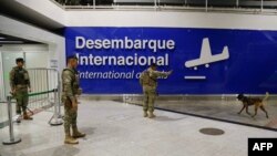FILE - Soldiers patrol in the arrival area of Juscelino Kubitschek airport in Brasilia, Brazil, March 30, 2023. 