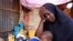 FILE - Hadiiq Abdulle Mohamed holds one of her children as she speaks during an interview with Associated Press at an internally displaced people camp on the outskirts of Mogadishu, Somalia, Friday, March 24, 2023. 