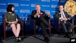 Paul Beckett, center, of the Wall Street Journal speaks about Journal reporter Evan Gershkovich at the National Press Club in Washington. With him are Gershkovich's sister Danielle Gershkovich, left, and Dow Jones & Co. General Counsel Jason Conti.