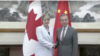 In this image taken from video, Canadian Foreign Minister Melanie Joly, left, shakes hands with Chinese Foreign Minister Wang Yi in Beijing on July 19, 2024. (CCTV via Reuters)