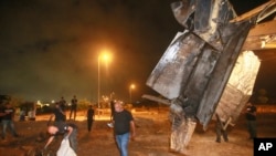 Israeli authorities inspect the remains of what the military said is a Syrian anti-aircraft rocket that exploded in the air, in the town of Rahat, Israel, July 2, 2023.