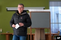 Chairman of the National Coalition Party Petteri Orpo walks to cast his ballot at a polling station during parliamentary election in Turku, Finland, April 2, 2023.