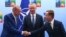 Turkey's President Recep Tayyip Erdogan, left, shakes hands with Sweden's Prime Minister Ulf Kristersson, right, as NATO Secretary-General Jens Stoltenberg looks on prior to a meeting ahead of a NATO summit in Vilnius, Lithuania, July 10, 2023. 