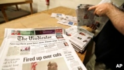 FILE- This Aug. 6, 2019, photo shows The Vindicator newspaper prepared for delivery in Liberty Township near Youngstown, Ohio. The Vindicator, a 150-year-old paper, shut down a few weeks later because of financial struggles.