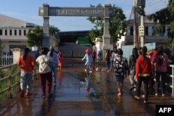 FILE - Garment workers walk to their factory in Phnom Penh on September 20, 2019.