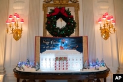 Holiday decorations adorn the State Dining Room of the White House for the 2023 theme "Magic, Wonder, and Joy," Monday, Nov. 27, 2023, in Washington. (AP Photo/Evan Vucci)