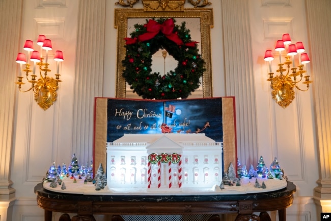 Holiday decorations adorn the State Dining Room of the White House for the 2023 theme "Magic, Wonder, and Joy," Monday, Nov. 27, 2023, in Washington. (AP Photo/Evan Vucci)