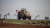 FILE - A US military vehicle on a patrol in the countryside near the town of Qamishli, Syria, Dec. 4, 2022. 