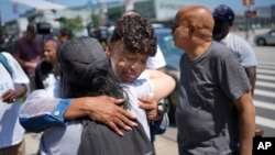 Gwen Carr, mother of Eric Garner, greets friends and family at the start of a commemoration of Garner's death in the Staten Island borough of New York, July 17, 2024.