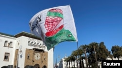 Protesters display a flag with an image of a Palestinian militant, at a demonstration calling for an end to Morocco's ties with Israel, amid the ongoing conflict between Israel and Hamas, in Rabat, Morocco on Sunday December 24, 2023.