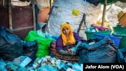 A Rohingya ragpicker separates recyclable trash at a refugee camp in Haryana.