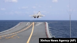 FILE - In this photo released by Xinhua News Agency, a J-15 Chinese fighter jet takes off from the Shandong aircraft carrier during military exercises around Taiwan by the Eastern Theater Command of the Chinese People's Liberation Army on April 9, 2023.