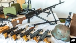 This picture provided by the Austrian Interior Ministry on June 29, 2023, shows secured weapons, objects and ammunitions. 