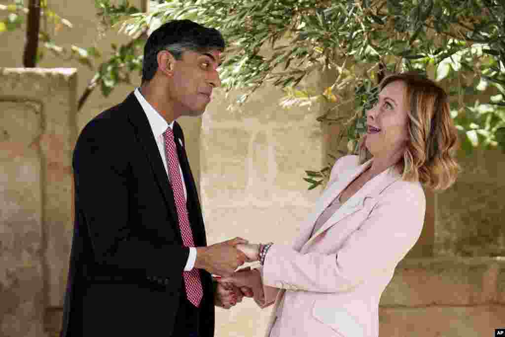 British Prime Minister Rishi Sunak, left, is welcomed by Italian Prime Minister Giorgia Meloni during a G7 world leaders summit at Borgo Egnazia, southern Italy.
