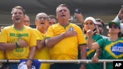 Former Brazilian President Jair Bolsonaro, center, acknowledges supporters during a rally in Sao Paulo, Brazil, Feb. 25, 2024. Bolsonaro and some of his former top aides are under investigation over allegedly plotting a coup to remove his successor, Luis Inacio Lula da Silva.