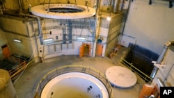 FILE - Technicians work on the Arak heavy water reactor's secondary circuit, near Arak, 250 kilometers southwest of Tehran, Iran, Dec. 23, 2019. (Atomic Energy Organization of Iran handout)