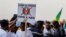 FILE— A supporter of the Alliance Of Sahel States holds a placard reading 'down with ECOWAS, long live [the alliance]' during a rally to celebrate Mali, Burkina Faso and Niger leaving the Economic Community of West African States (ECOWAS) in Bamako on February 1, 2024. 