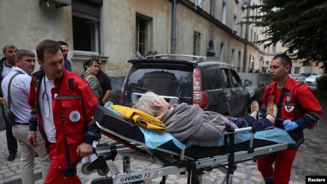Paramedics carry a person from a residential building hit by a Russian missile strike in Lviv, Ukraine, July 6, 2023.