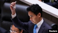Pita Limjaroenrat, leader of the Move Forward Party, holds up his ID card at Parliament after Thailand&#39;s Constitutional Court ordered his temporary suspension from the Parliament, on the day of the second vote for a new prime minister, in Bangkok.