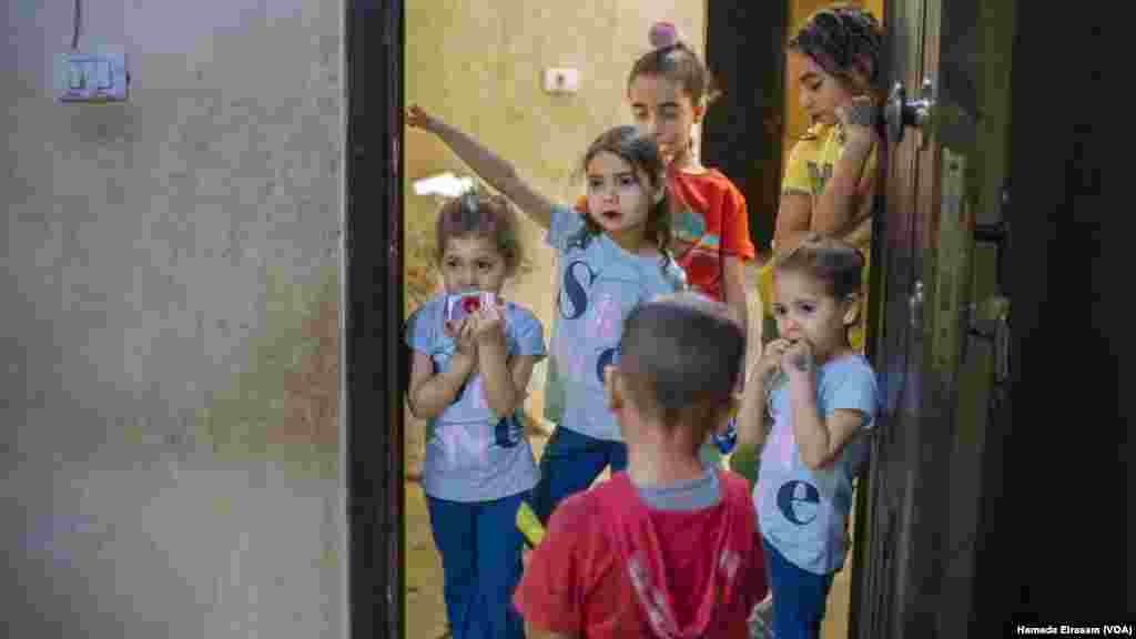 Ahead of Eid celebrations, young siblings visit their neighbors as part of a holiday custom in Egypt among children, who are also traditionally gifted a new set of clothes for the occasion.&nbsp;