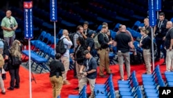 Security agents prepare for a sweep of the Fiserv Forum ahead of the 2024 Republican National Convention, July 13, 2024, in Milwaukee.