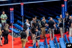 Security agents prepare for a sweep of the Fiserv Forum ahead of the 2024 Republican National Convention, July 13, 2024, in Milwaukee.