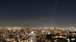 Israeli Iron Dome air defense system fires to intercept a rocket fired from the Gaza Strip, in central Israel, Nov. 21, 2023.